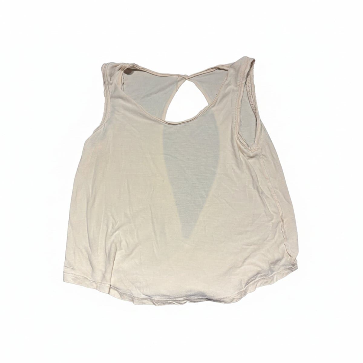 Minimalist cream-colored sleeveless tank top with an open-back design and raw-edge hem, available at handpicked306 boutique in Carlyle SK.