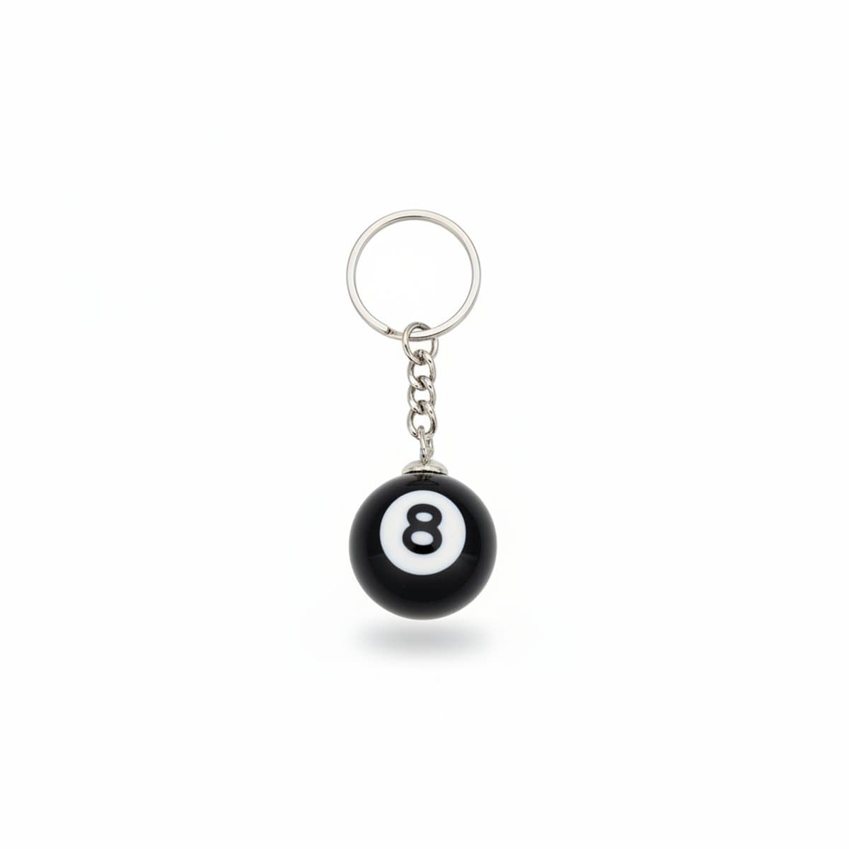 Retro style black and white 8-ball keychain on a rustic wooden background, available at handpicked306 boutique.