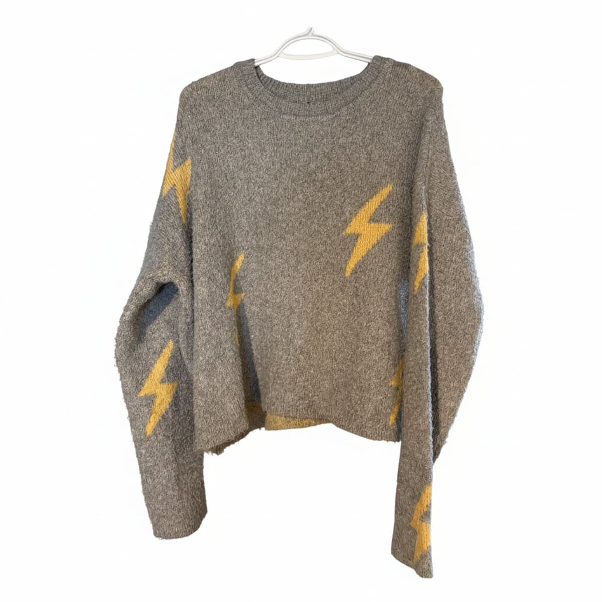 Women's grey sweater with yellow lightning bolt pattern, relaxed fit knitwear, available at handpicked306 boutique in Carlyle SK.