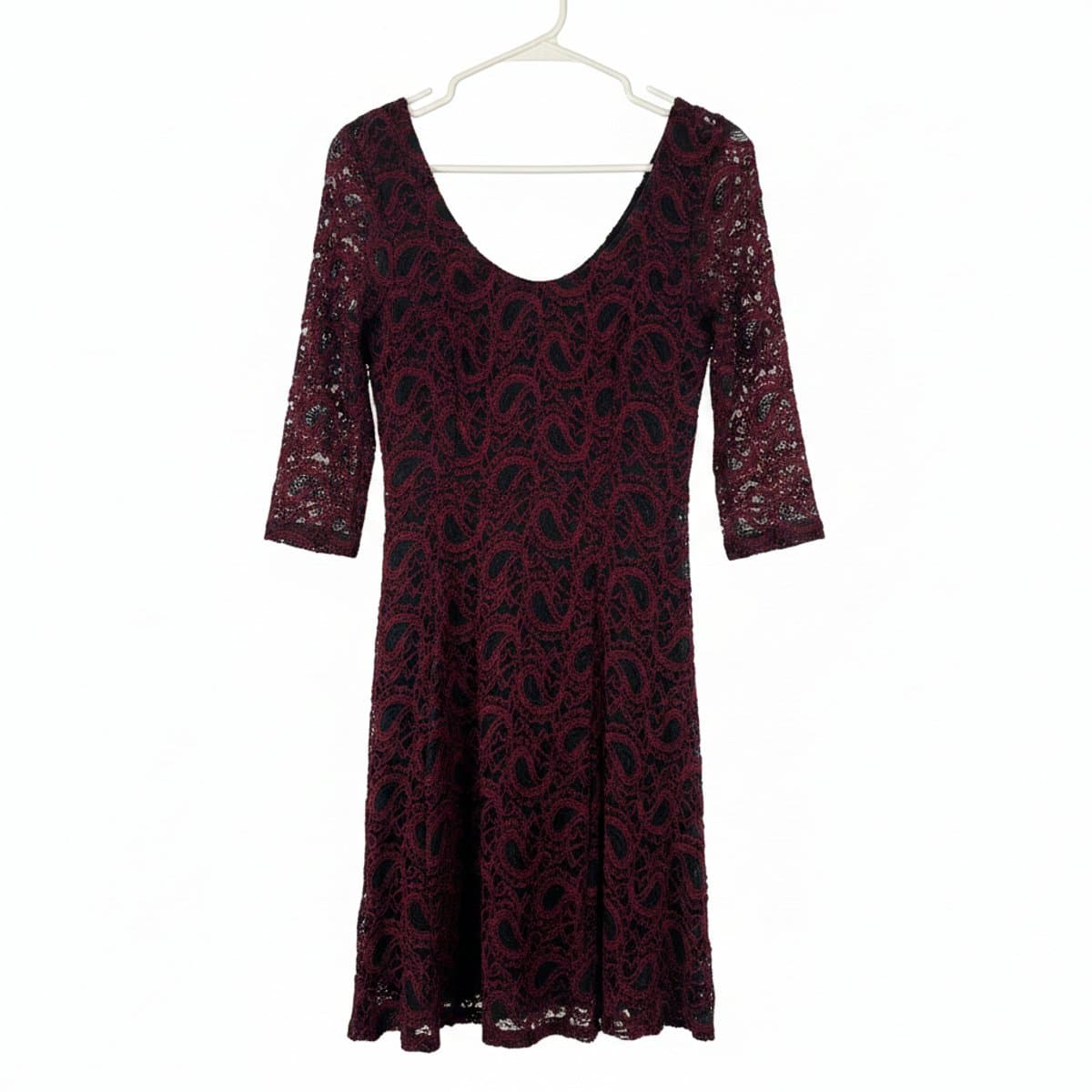 Vintage burgundy and black paisley lace midi dress with scoop neckline, hanging on a rack at handpicked306 boutique in Carlyle SK.