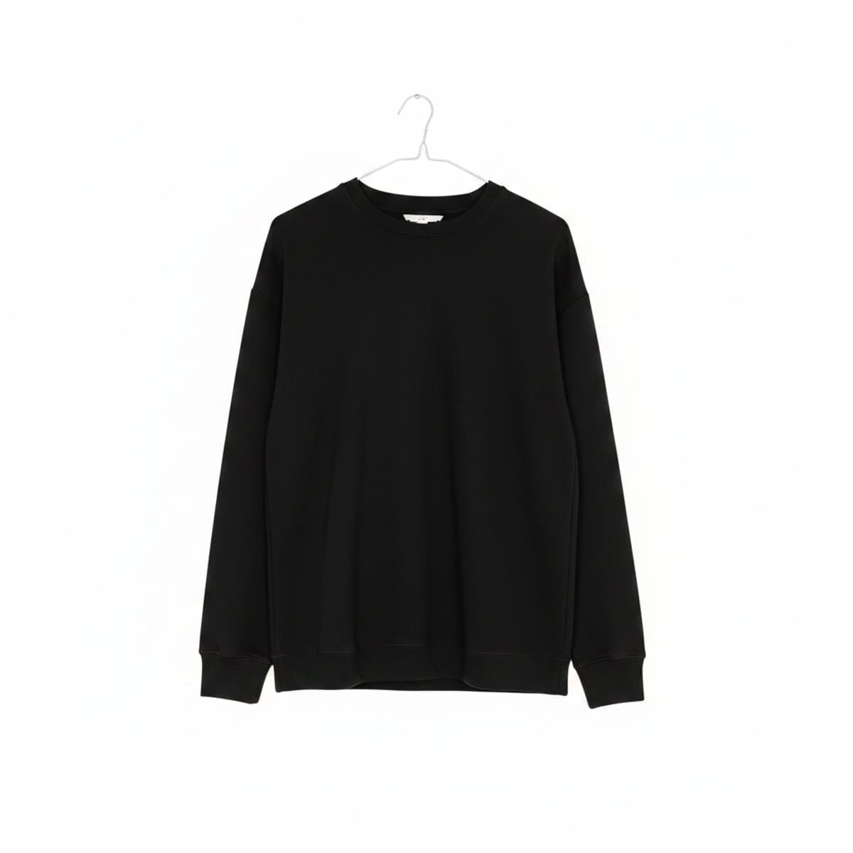 A minimalist black crewneck sweatshirt by Aritzia with a relaxed fit, photographed on a hanger, available at handpicked306 boutique in Carlyle SK.