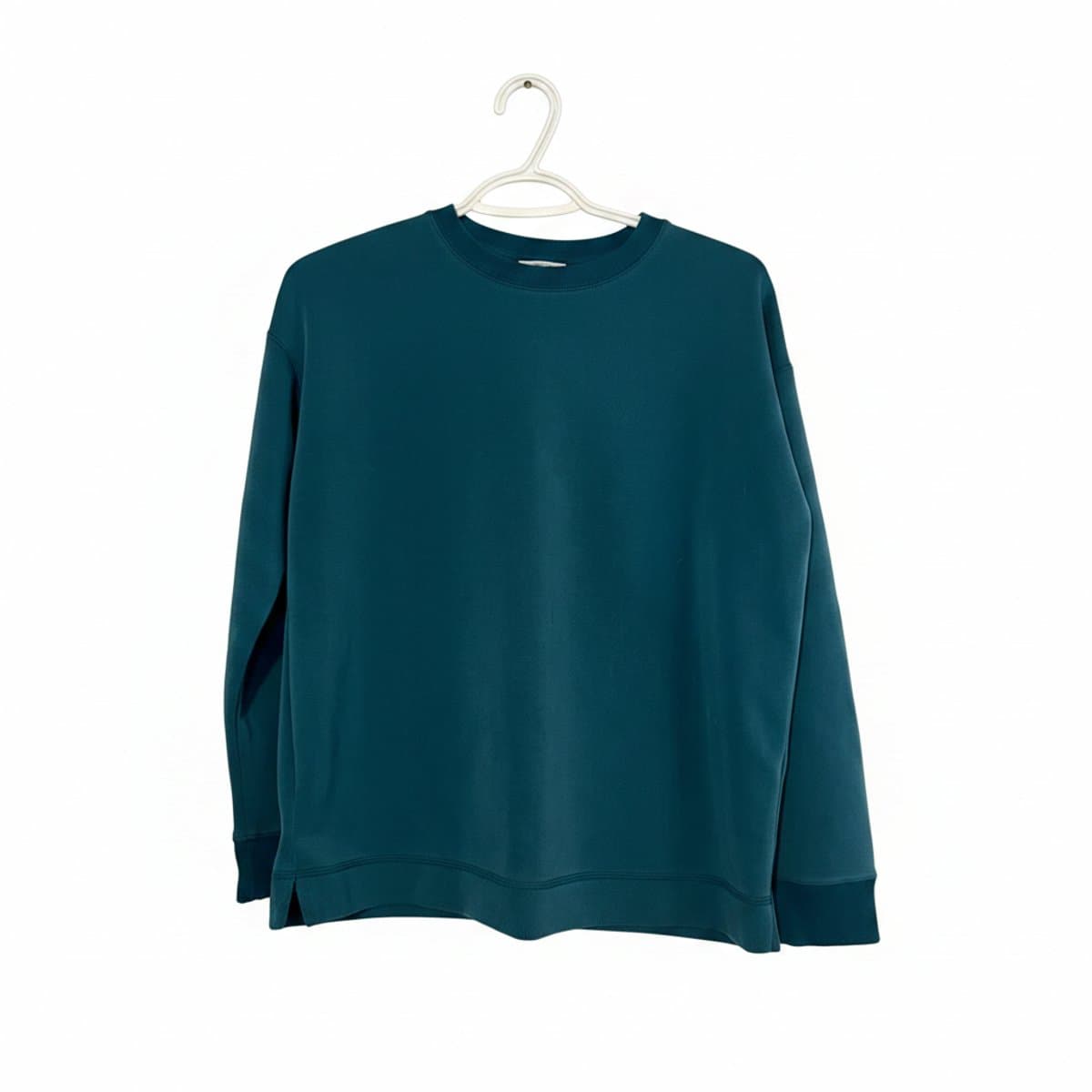 Minimalist deep teal crewneck sweatshirt with side slits, high-quality fabric, neutral everyday wear, available at handpicked306 boutique.