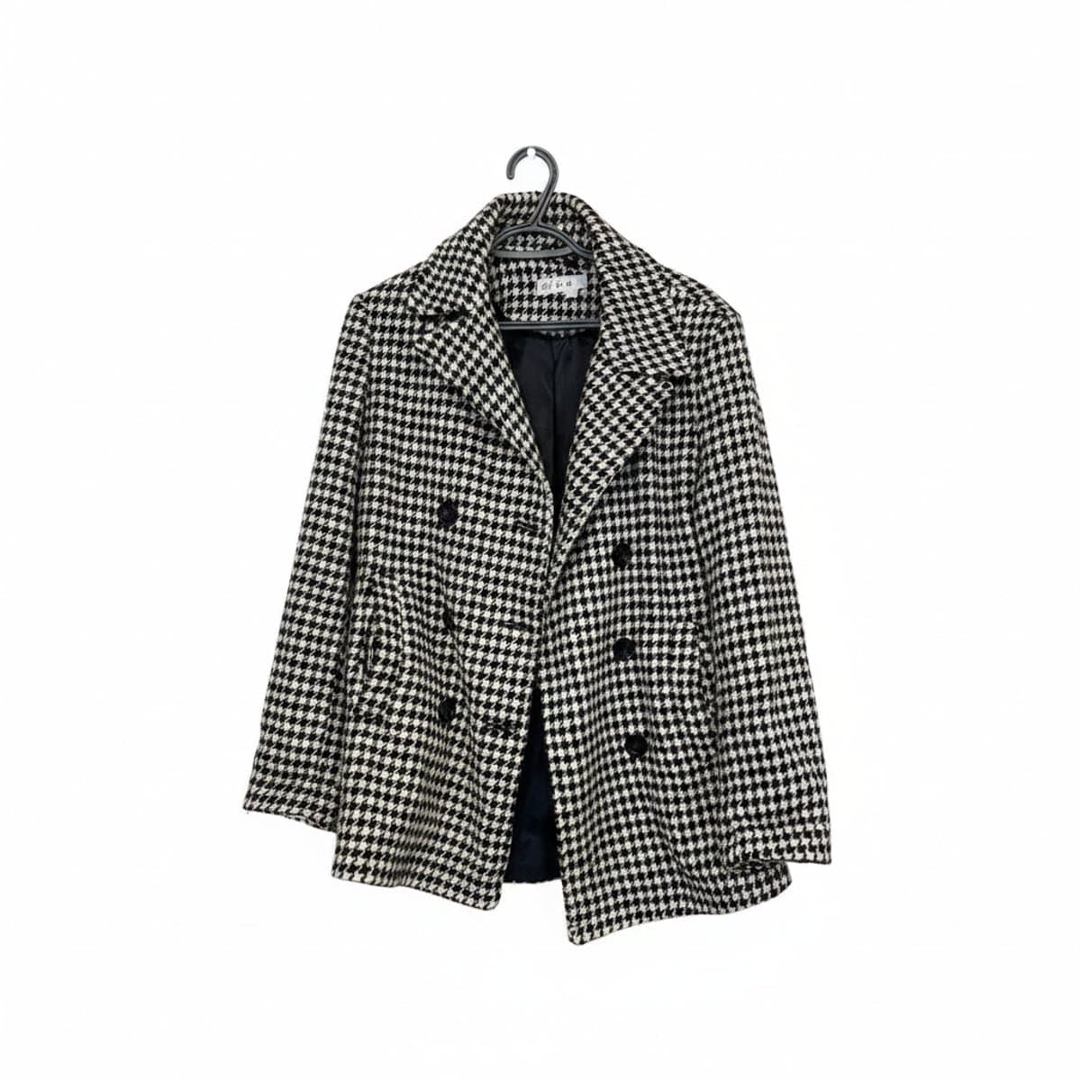 Cleo black and white houndstooth double-breasted jacket, structured tailored fit, classic pattern, available at handpicked306 boutique in Carlyle SK.