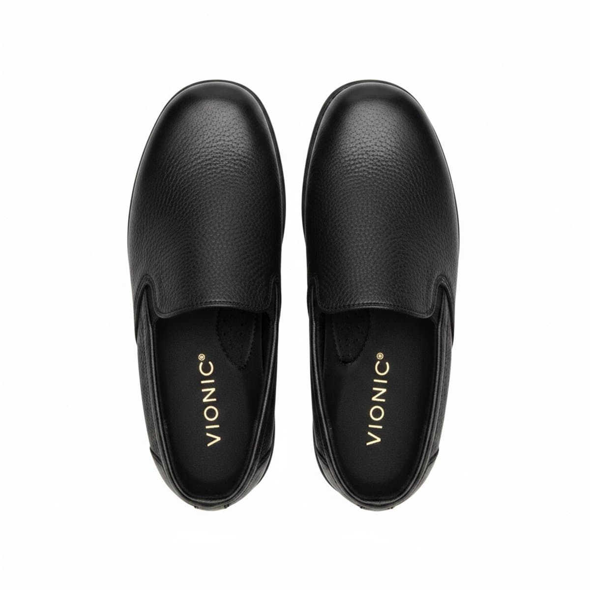 Pair of Vionic black textured leather mule slip-ons with gold-tone branding on the footbed, minimalist design, available at handpicked306 boutique in Carlyle SK.