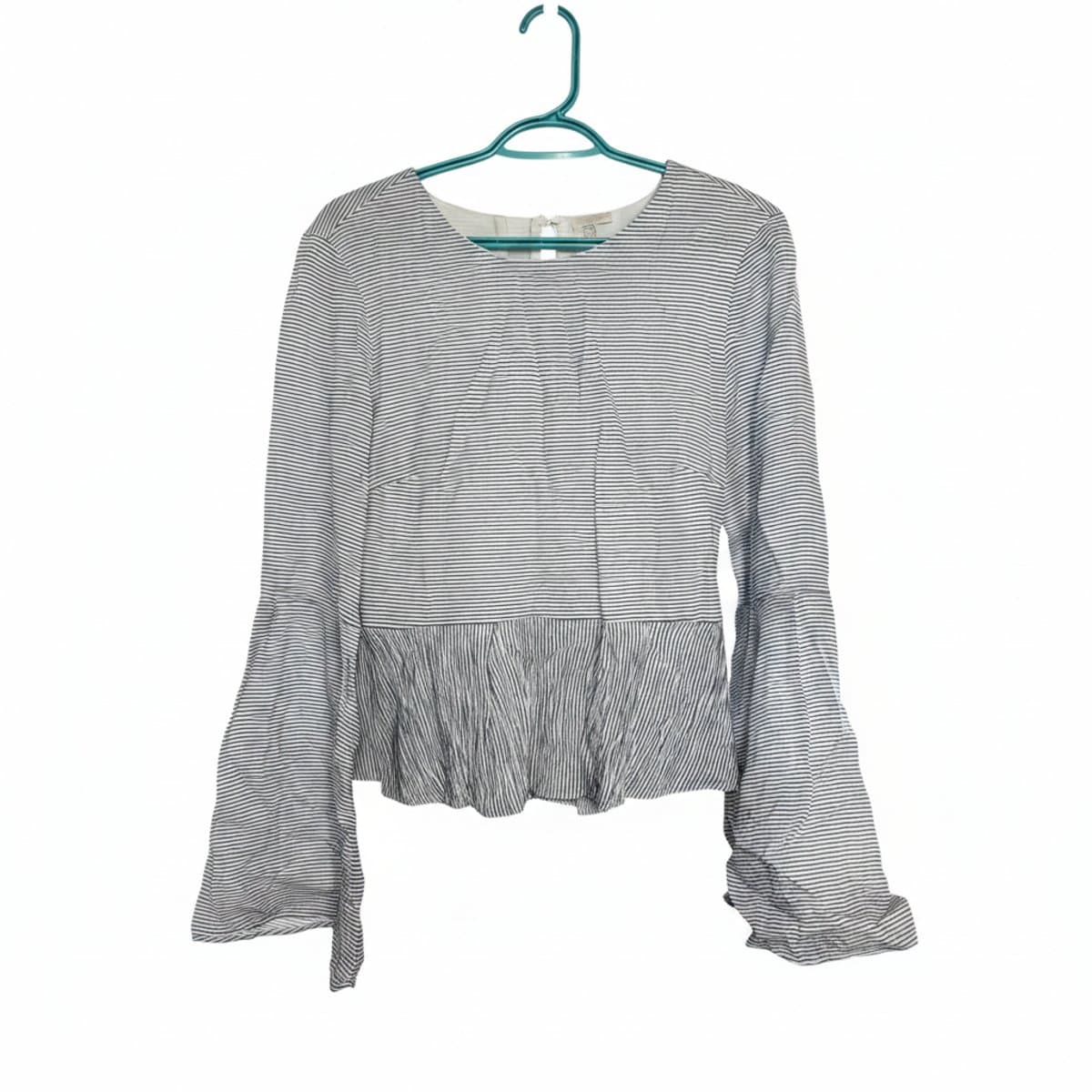 Womens striped long sleeve peplum blouse with flared bell sleeves, modern minimalist style, available at handpicked306 boutique in Carlyle SK.