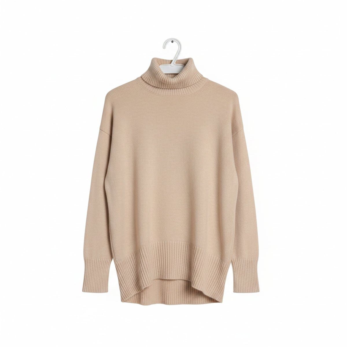 A soft beige turtleneck sweater with ribbed hem and cuffs hanging on a hanger, minimalist aesthetic, available at handpicked306 boutique in Carlyle SK.